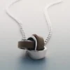 Collar Ormé, edición en plata rodiada con cuero color topo